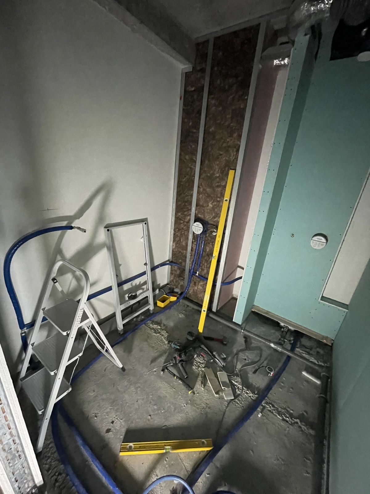 Plumbing and wall preparation, with pipework and service positions set out before the floor finishes.