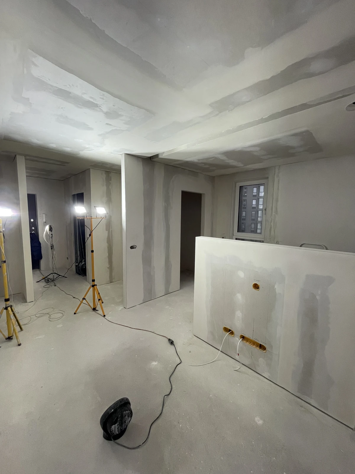 Board joints being finished across the ceilings and new partitions.