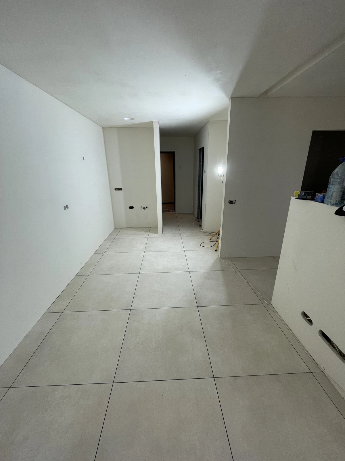 The tiled floor and decorated walls as the main living space takes shape.