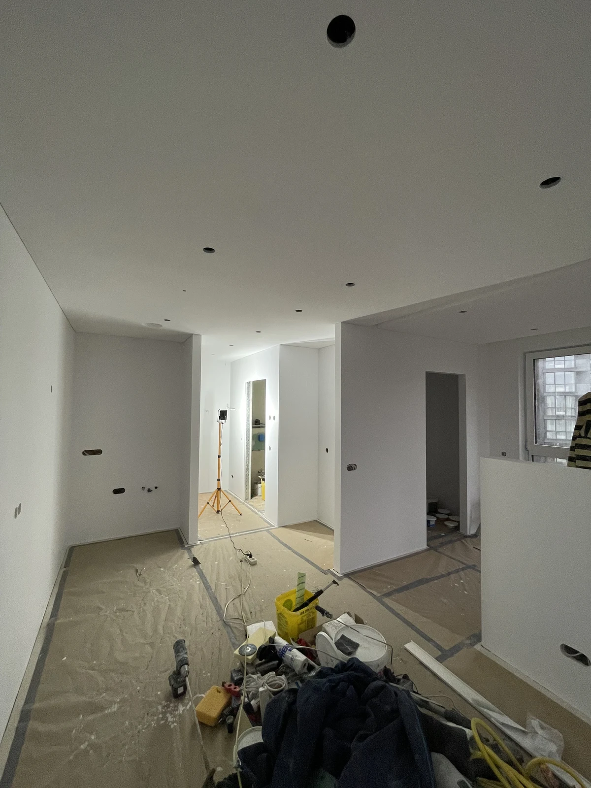 Flooring and ceiling preparation during the apartment fit-out.