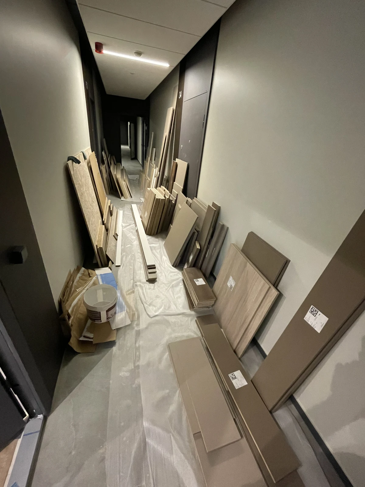 Furniture panels and components organised for on-site assembly.
