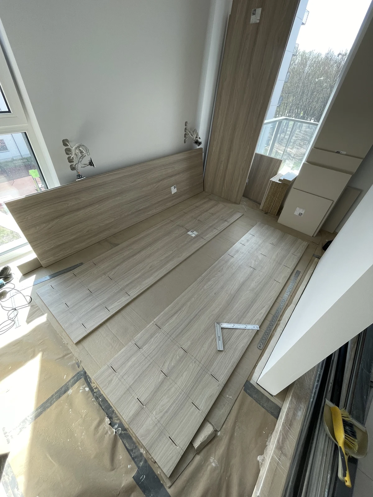 Timber wall panelling being fitted beside the windows.
