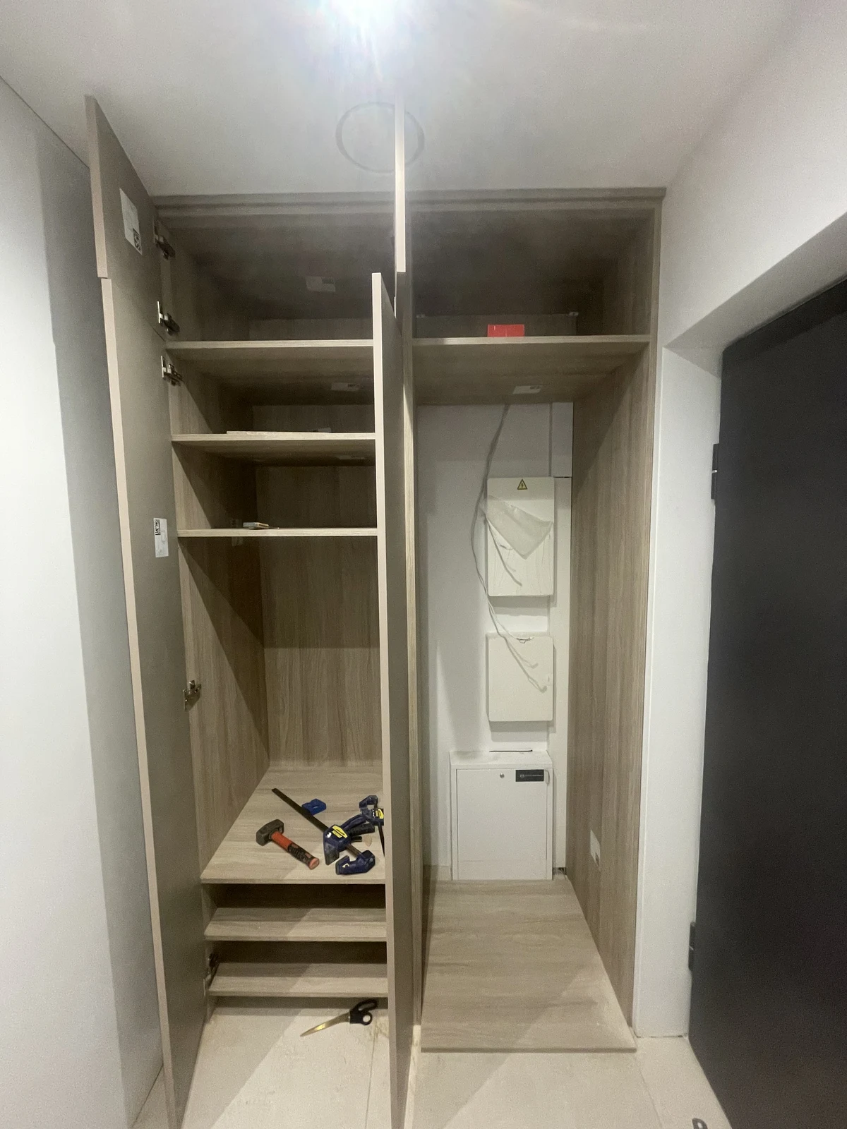 A full-height fitted wardrobe during assembly.