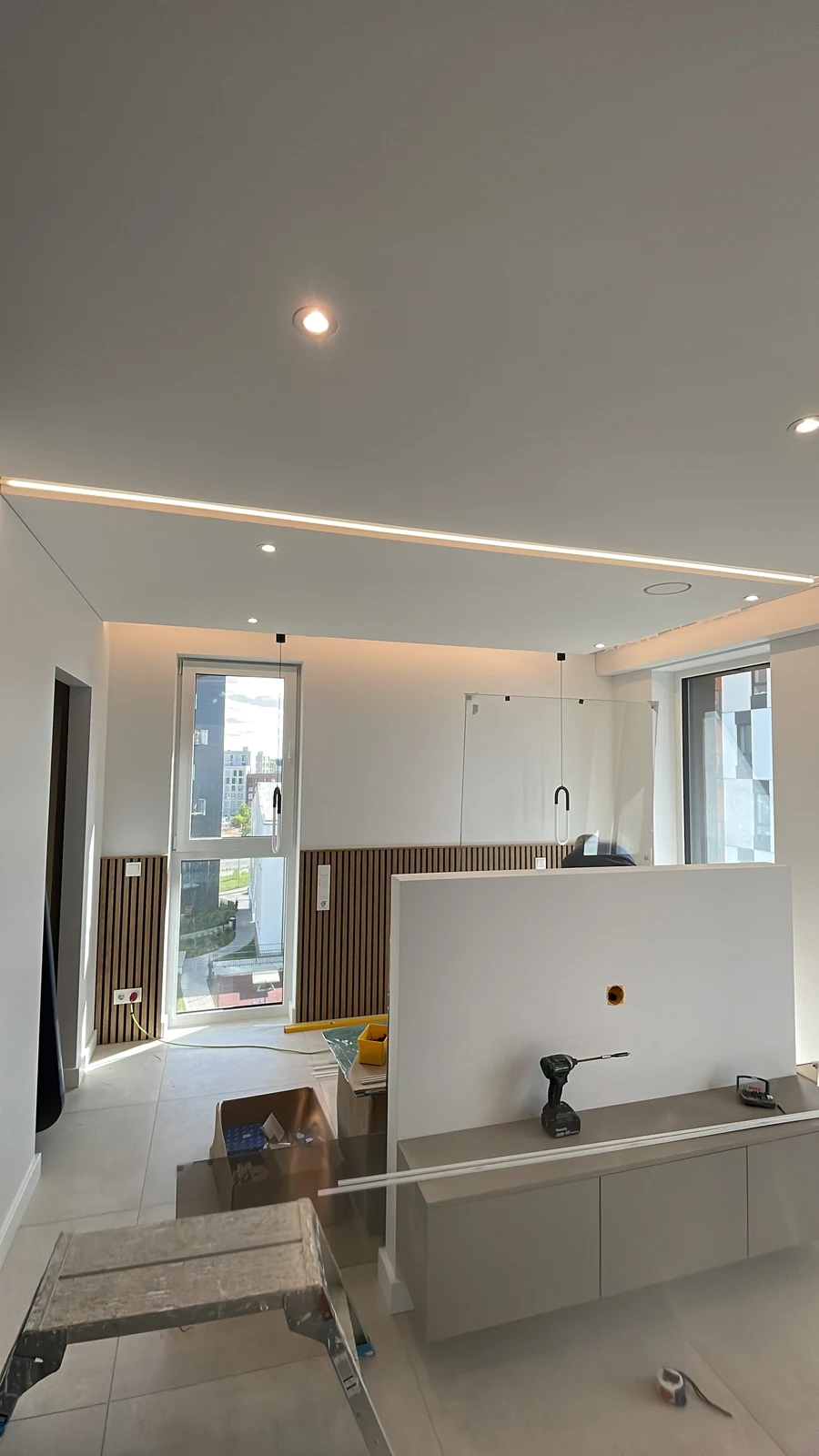 Integrated ceiling lighting during the final apartment fit-out.