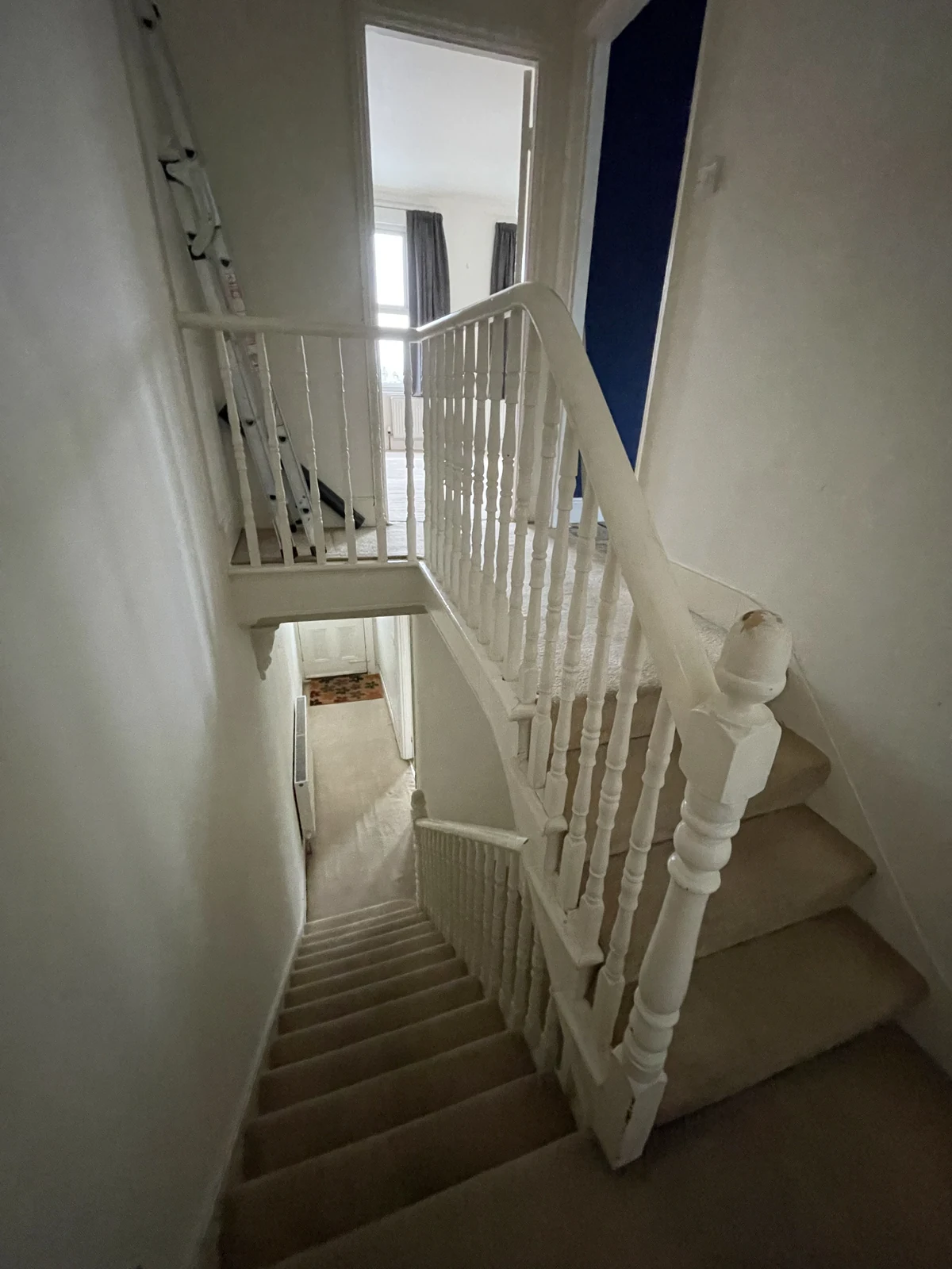 The original carpeted stairs and landing