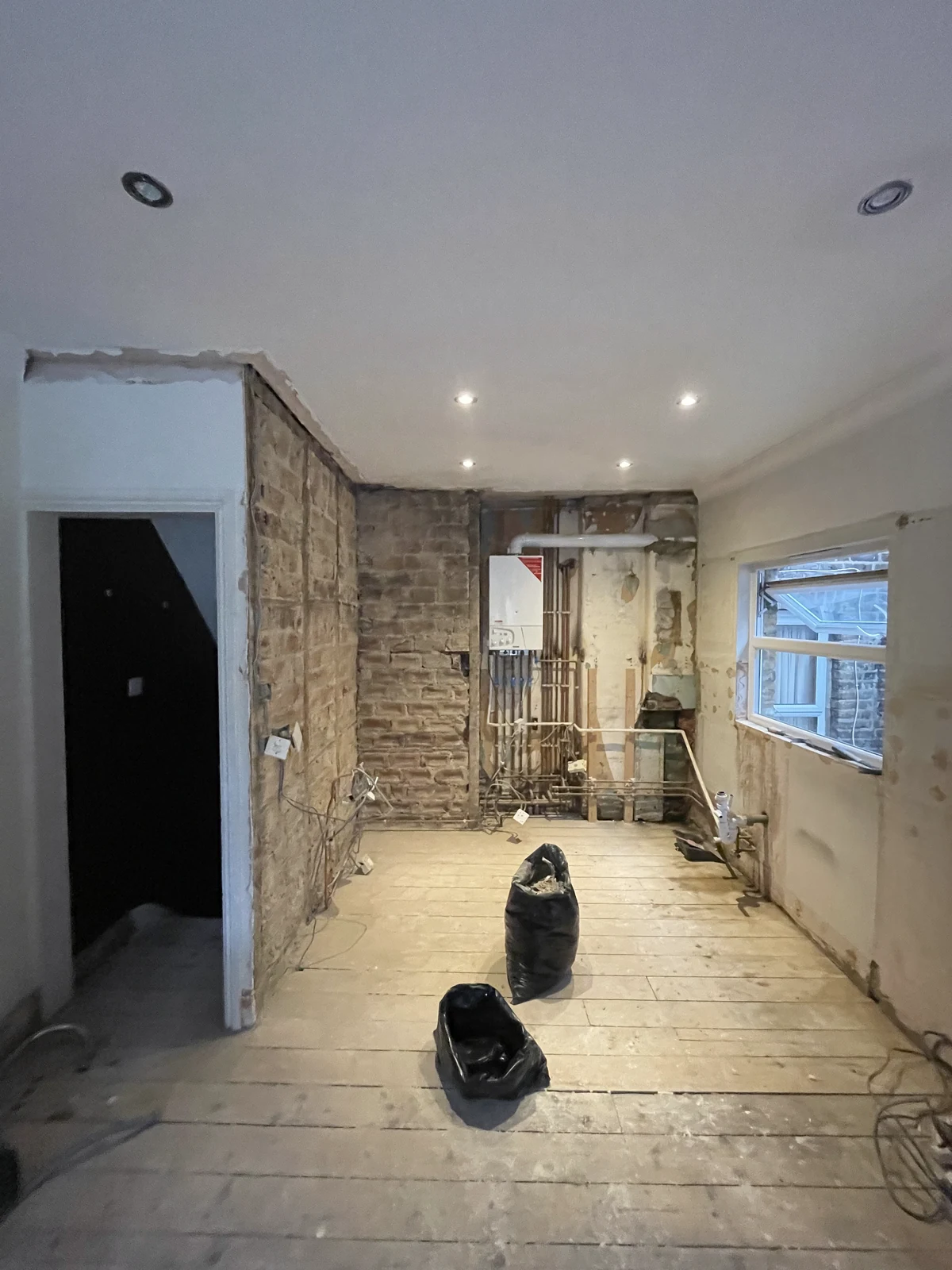Kitchen strip-out exposing the original walls and floorboards