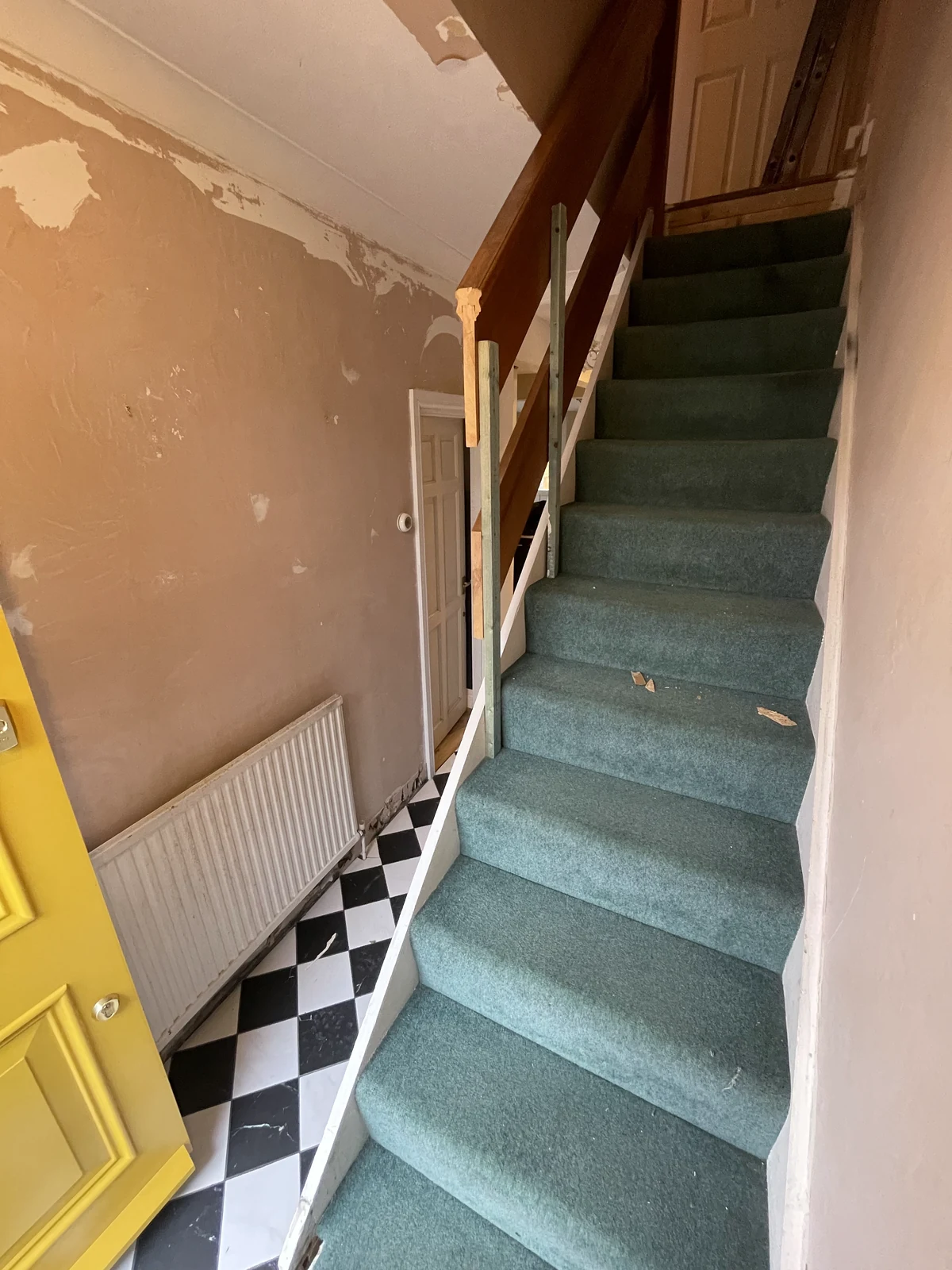 Hall and stairs at the start of the renovation, with the earlier carpet and wall finishes