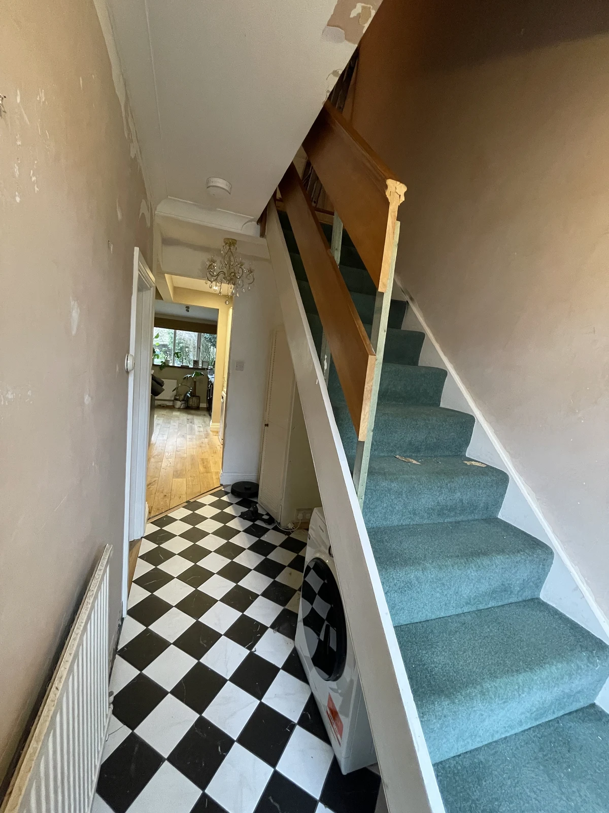 The original carpeted staircase and hallway before renovation.