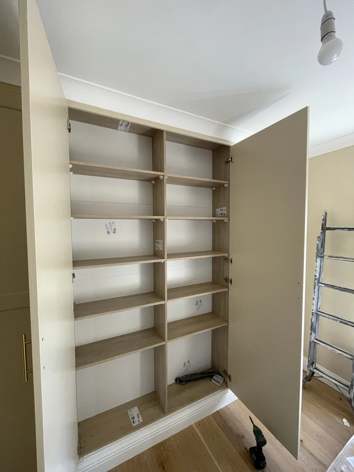 Open wardrobe showing fitted shelving and a hanging rail.
