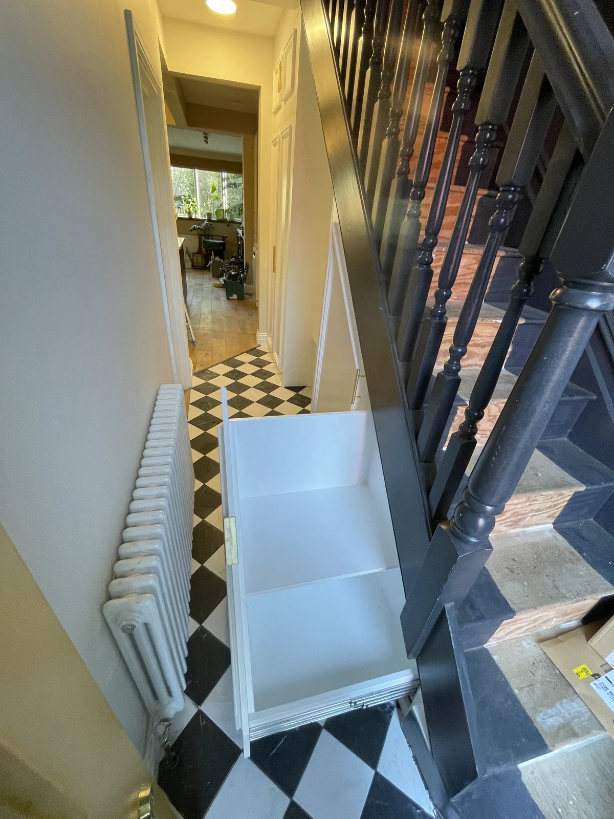 Pull-out under-stair storage in the hallway.