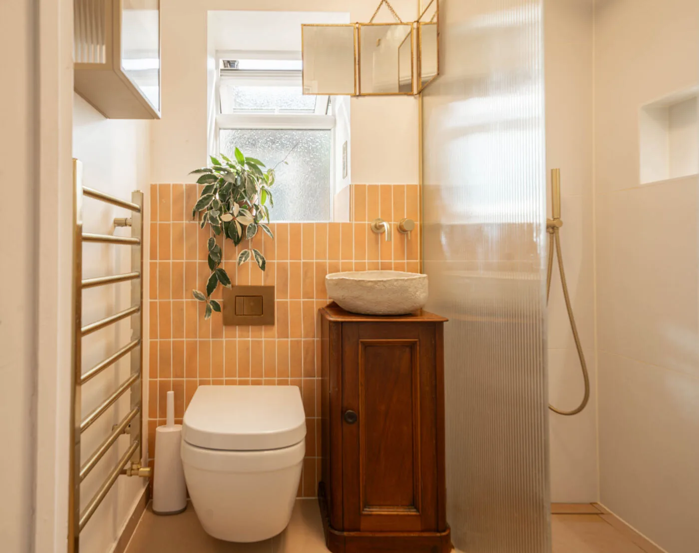 Finished Wanstead wet room with wall-hung toilet, timber vanity and ribbed glass shower screen