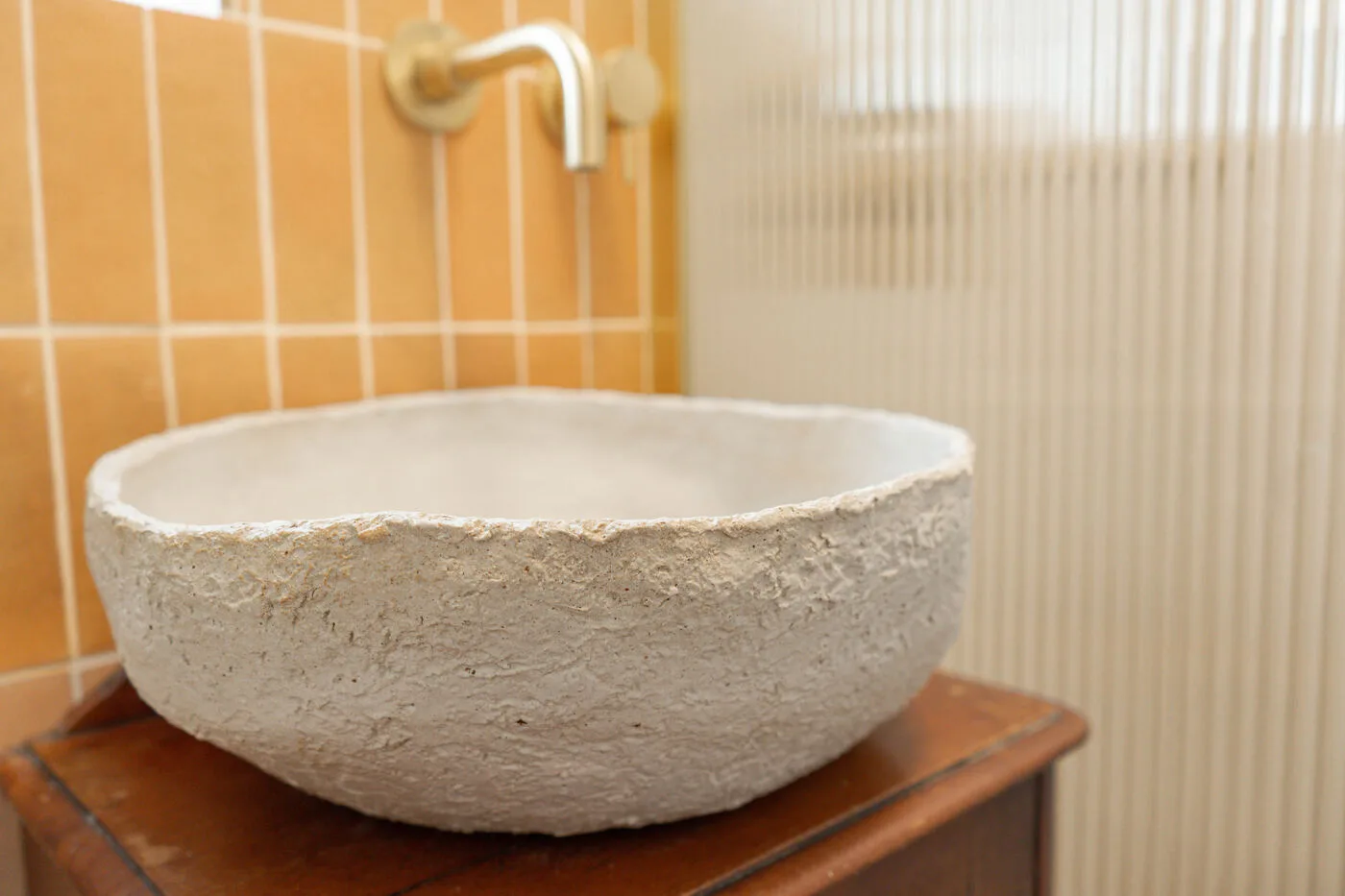 Stone countertop basin with wall-mounted tap