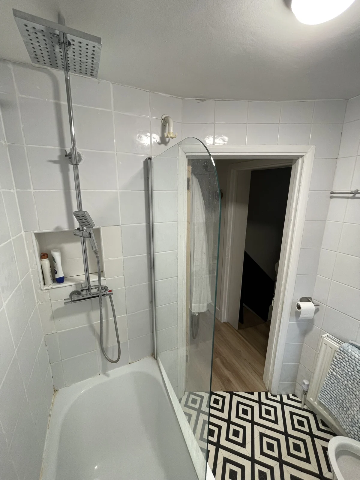 The original bath and shower arrangement before conversion to a wet room