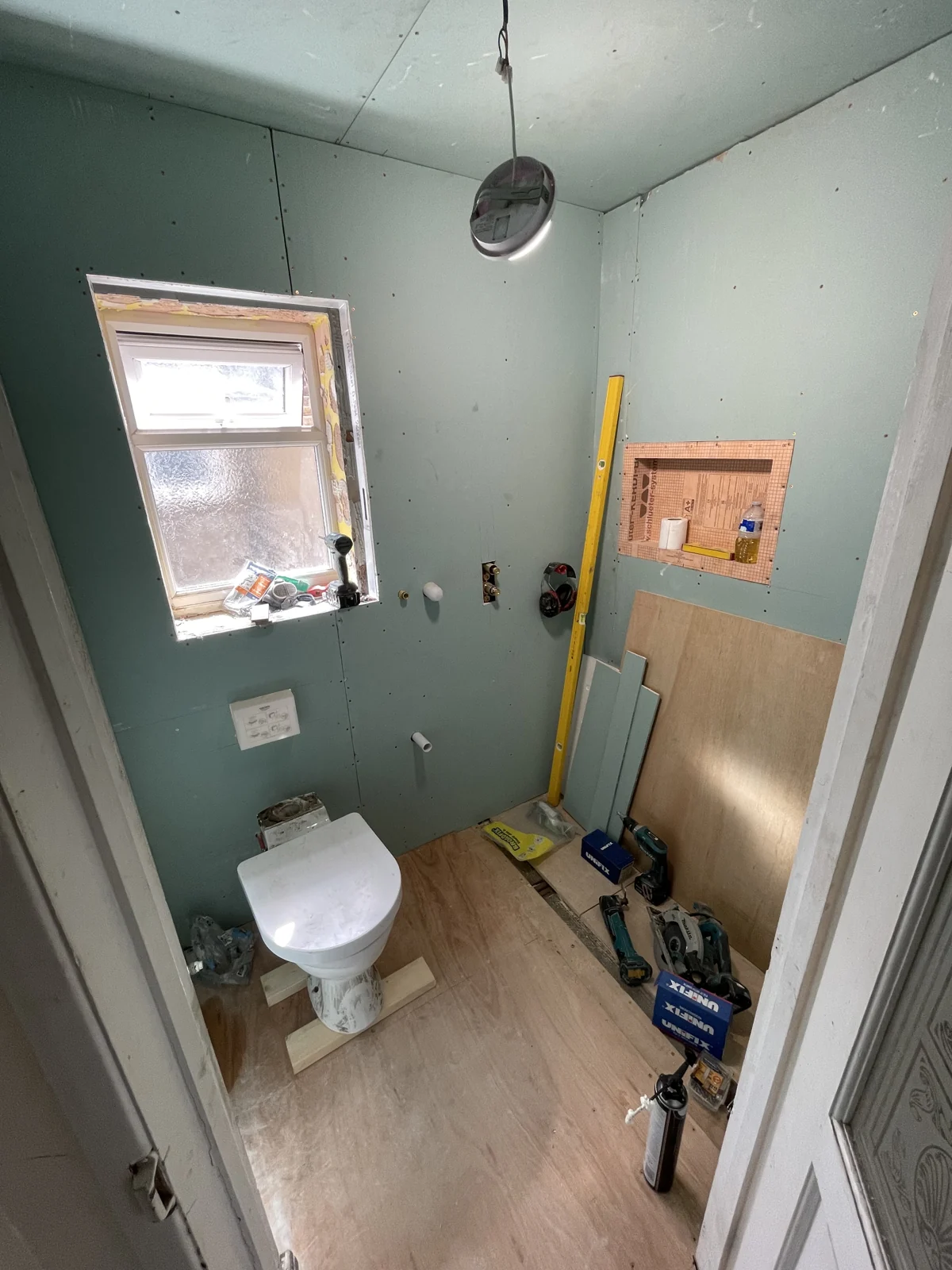New wall boarding and concealed toilet frame during the rebuild
